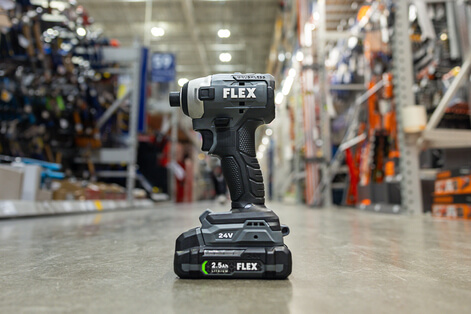 Flex brand drill sitting in the aisle of a Lowes Home Improvement. 